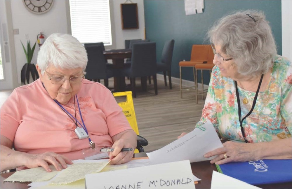 Betty Jackson, right, asks a question of Joanne McDonald at a recent memoir writing class entitled "You Are Unique." Class members write stories about their life that are published every four months.